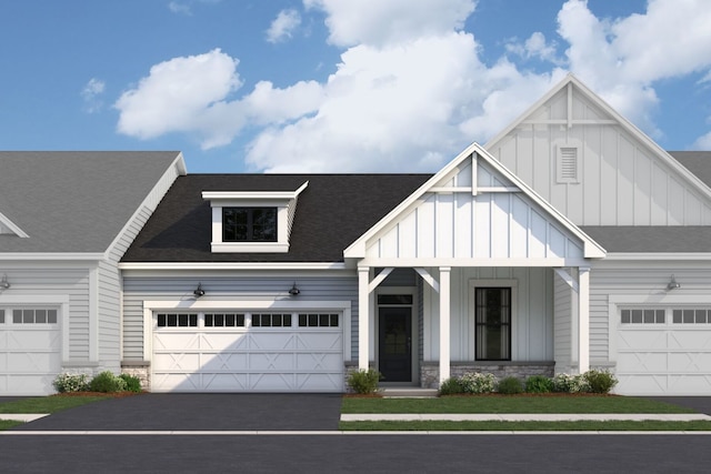 view of front facade featuring stone siding, a shingled roof, board and batten siding, and aphalt driveway