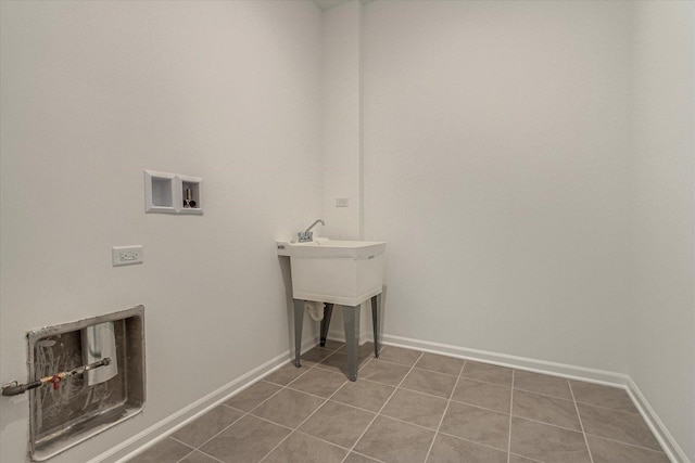 washroom featuring tile patterned floors, washer hookup, laundry area, and baseboards