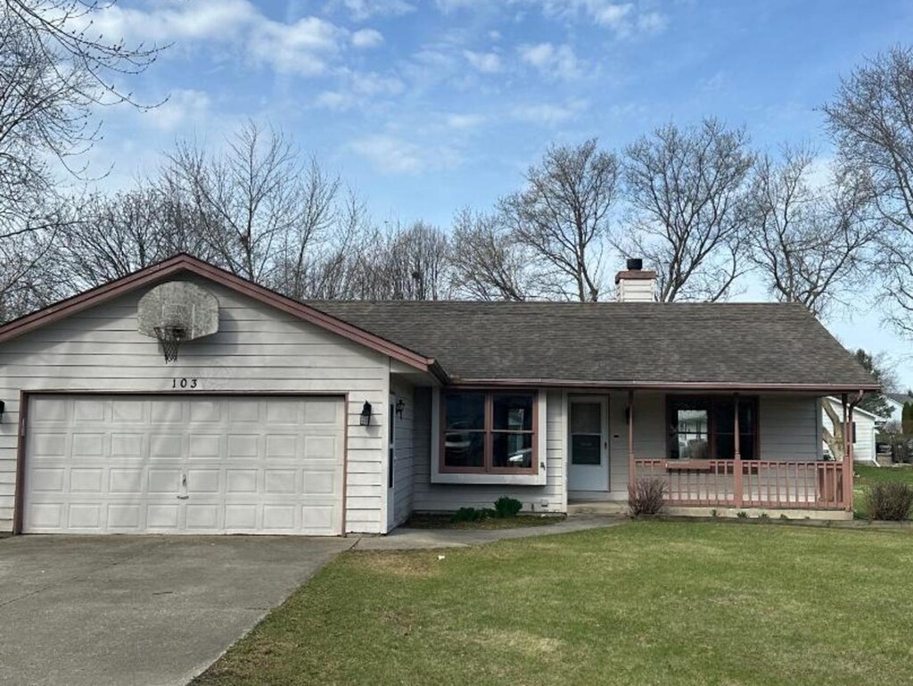 view of front of property featuring concrete driveway, a chimney, a front yard, an attached garage, and a porch