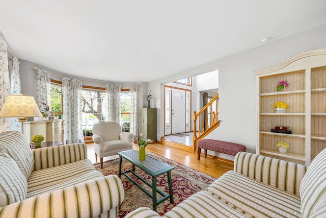 living area with wood finished floors and stairs
