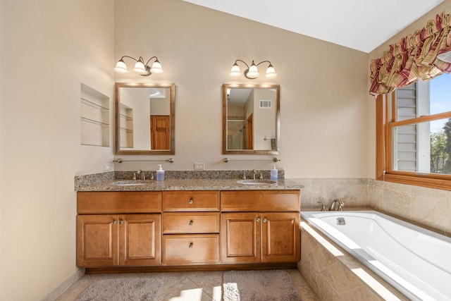 full bath featuring a garden tub, double vanity, and tile patterned floors