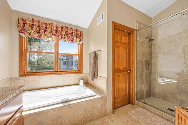 bathroom with a shower stall, a bath, lofted ceiling, and tile patterned floors