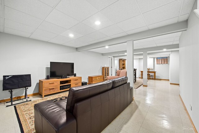 living area with baseboards, recessed lighting, and a paneled ceiling