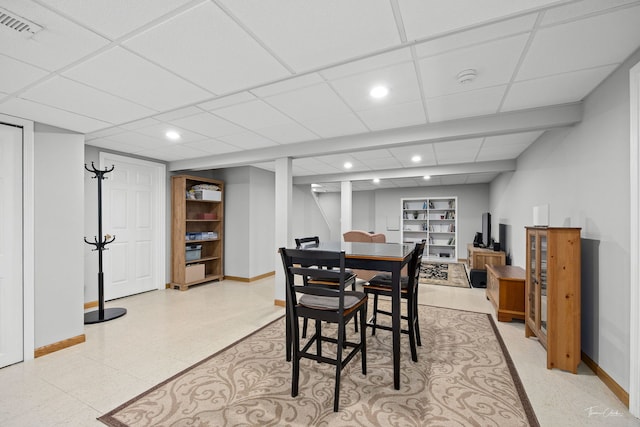 dining space with baseboards, recessed lighting, a paneled ceiling, and light floors