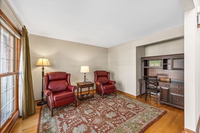 living area featuring wood finished floors and baseboards