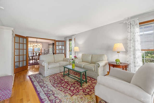 living room with a chandelier and wood finished floors