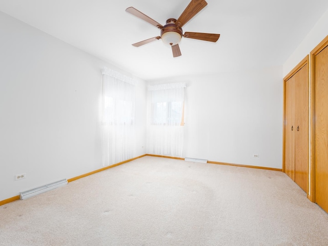 unfurnished bedroom featuring carpet floors, baseboards, ceiling fan, and visible vents