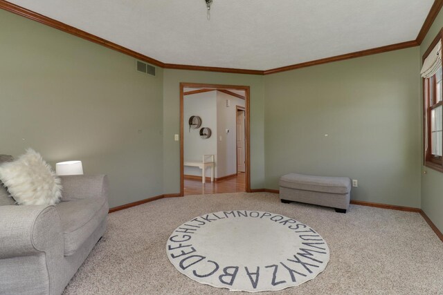 living area featuring crown molding, baseboards, visible vents, and carpet