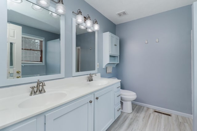 bathroom featuring double vanity, visible vents, and a sink