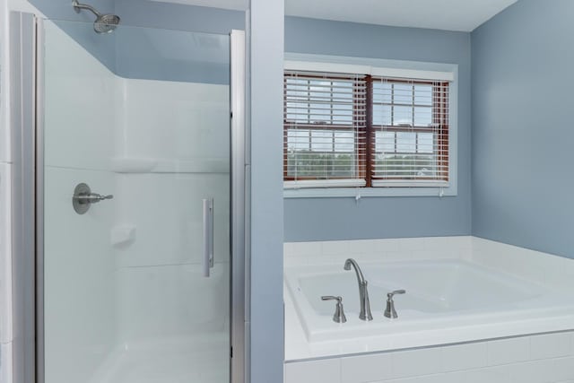bathroom with a garden tub and a shower stall