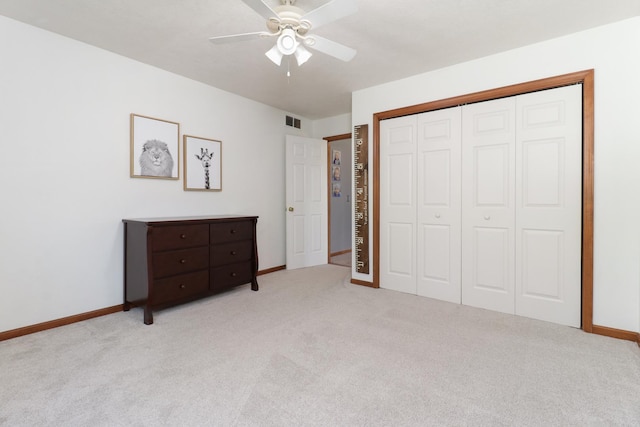 unfurnished bedroom with carpet floors, baseboards, visible vents, and a closet