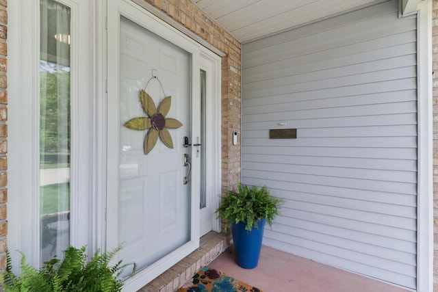 view of exterior entry featuring a porch