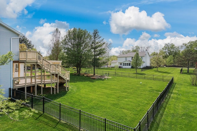 view of yard with stairway, a wooden deck, and a fenced backyard