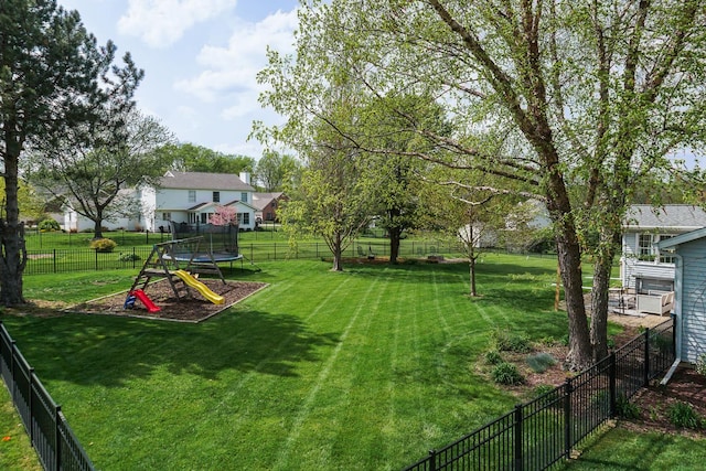 view of yard with a fenced backyard and a trampoline