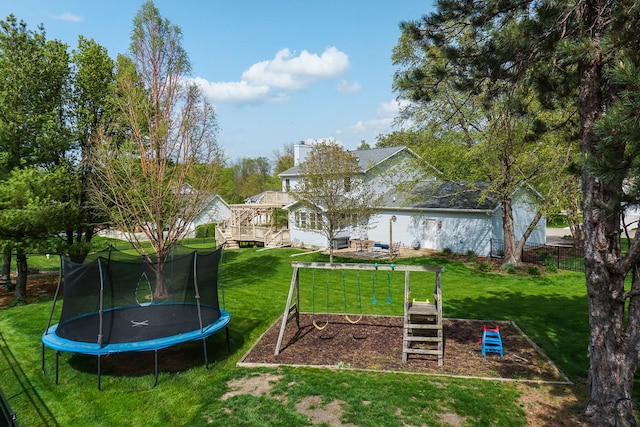 view of yard featuring fence and a trampoline
