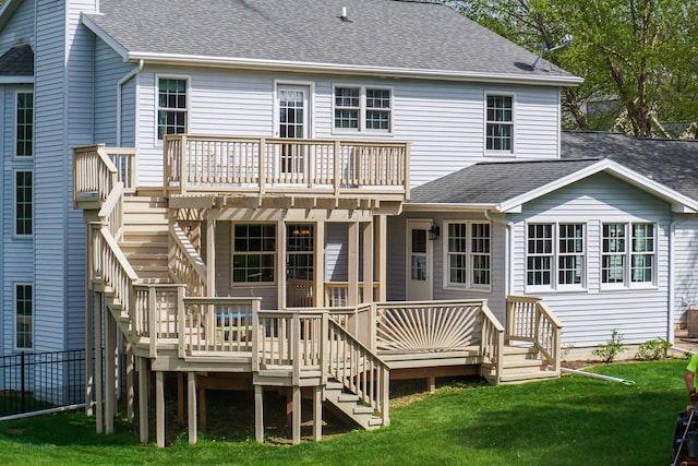 rear view of house featuring stairs, a shingled roof, and a wooden deck