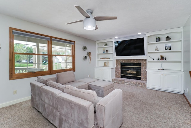 carpeted living area featuring a ceiling fan, baseboards, recessed lighting, and a fireplace