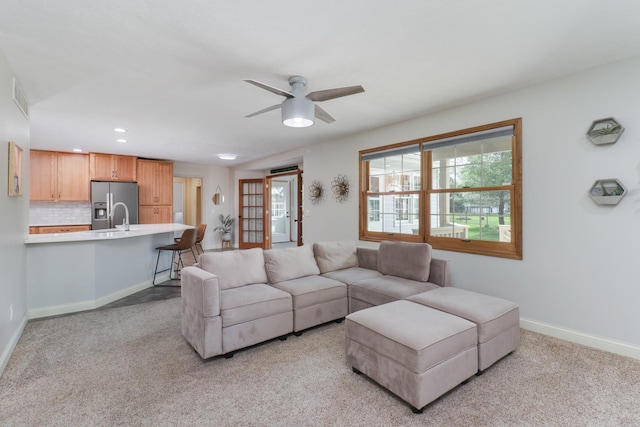 living area with visible vents, recessed lighting, ceiling fan, and light colored carpet