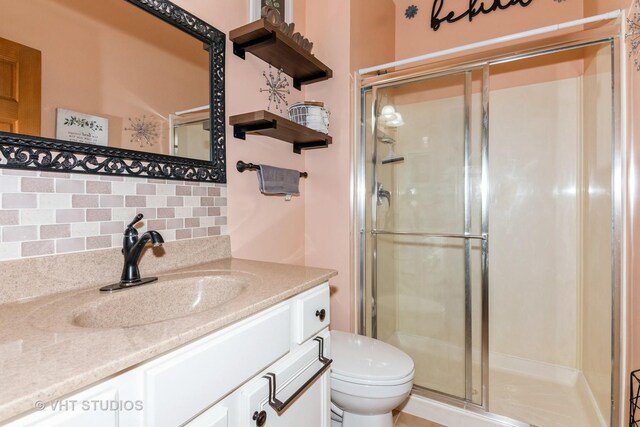 38W424 Berquist Dr, Geneva, IL 60134 - bathroom featuring toilet, decorative backsplash, a shower stall, and vanity