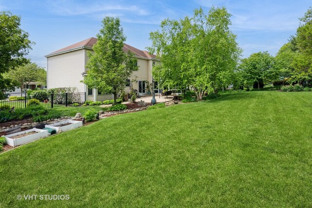 38W424 Berquist Dr, Geneva, IL 60134 - view of yard featuring a patio area and a vegetable garden