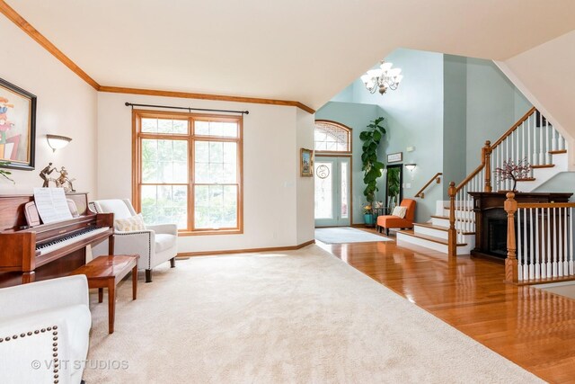 38W424 Berquist Dr, Geneva, IL 60134 - carpeted foyer featuring stairway, a chandelier, wood finished floors, baseboards, and crown molding