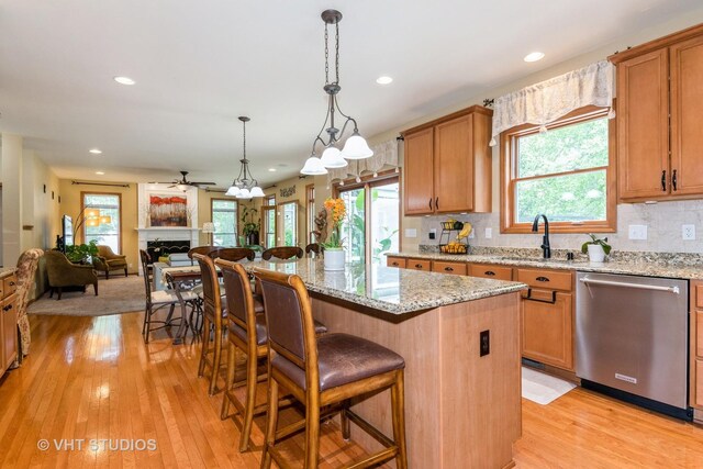 38W424 Berquist Dr, Geneva, IL 60134 - kitchen featuring dishwasher, a sink, open floor plan, plenty of natural light, and recessed lighting