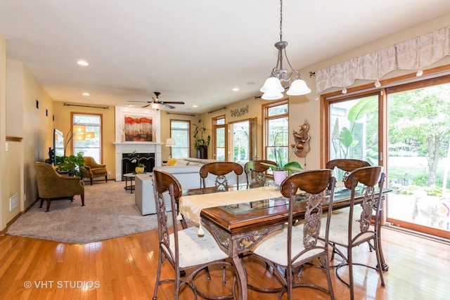 38W424 Berquist Dr, Geneva, IL 60134 - dining space featuring light wood-type flooring, recessed lighting, ceiling fan, a fireplace, and baseboards