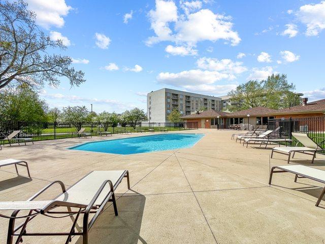 pool with fence and a patio