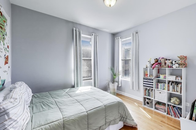 bedroom featuring baseboards and wood finished floors