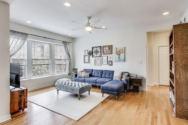 living room with baseboards, ceiling fan, recessed lighting, and light wood-style flooring
