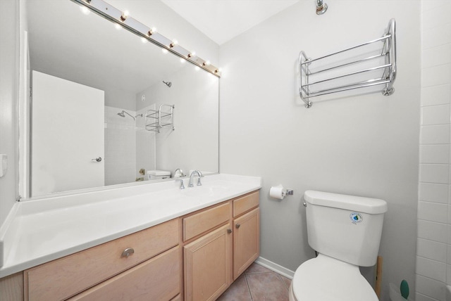 full bathroom featuring tile patterned flooring, vanity, toilet, baseboards, and a shower