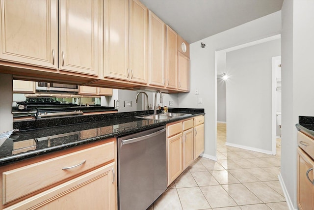 kitchen featuring a sink, light brown cabinetry, baseboards, and stainless steel dishwasher