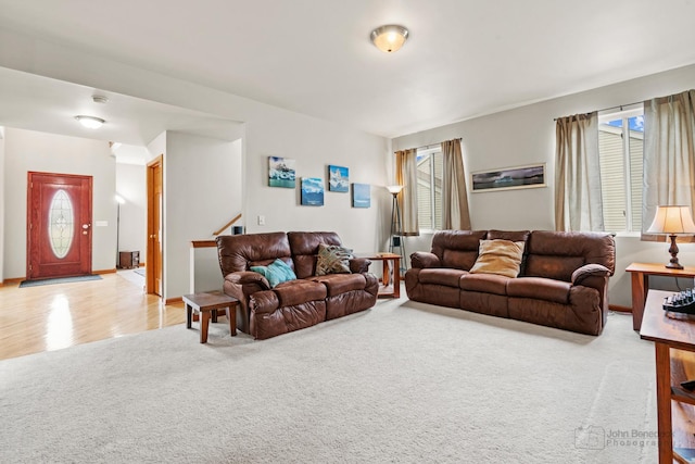 486 Devonaire Pkwy, Dekalb, IL 60115 - living area featuring healthy amount of natural light, stairs, and light carpet