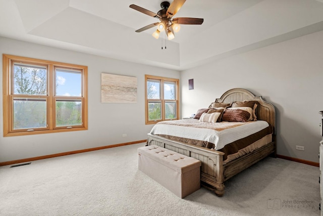486 Devonaire Pkwy, Dekalb, IL 60115 - carpeted bedroom featuring a raised ceiling, baseboards, and ceiling fan