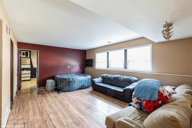 bedroom featuring visible vents and wood finished floors