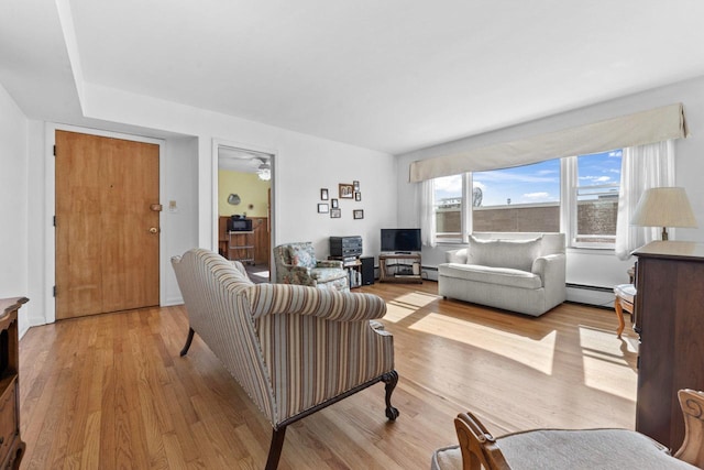 5927 W Addison St Unit 2D, Chicago, IL 60634 - living area featuring light wood finished floors and a baseboard radiator