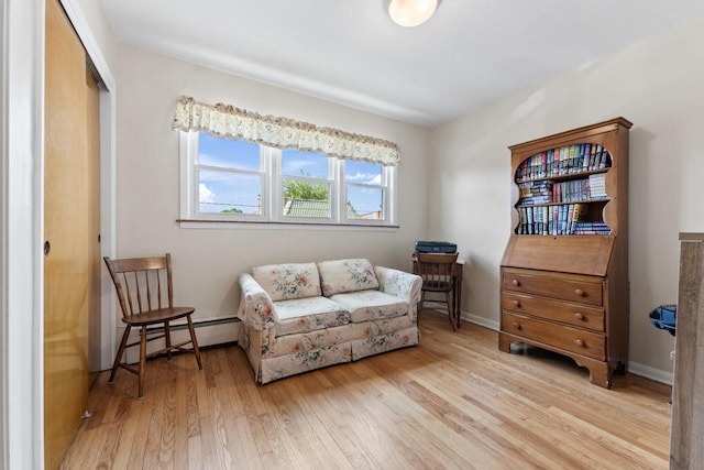 5927 W Addison St Unit 2D, Chicago, IL 60634 - living area with baseboard heating, wood finished floors, and baseboards