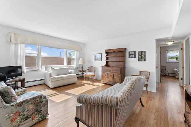 5927 W Addison St Unit 2D, Chicago, IL 60634 - living area with a baseboard heating unit and light wood-style floors
