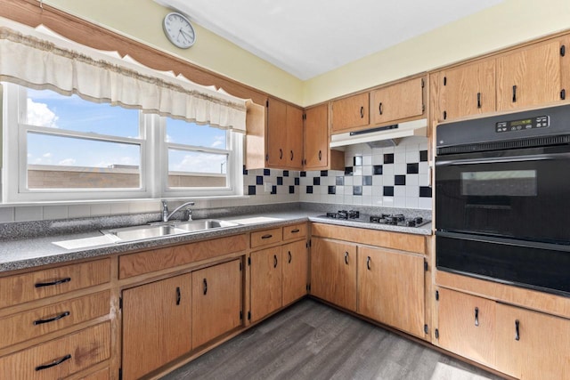 5927 W Addison St Unit 2D, Chicago, IL 60634 - kitchen featuring black appliances, a warming drawer, under cabinet range hood, tasteful backsplash, and dark wood-type flooring