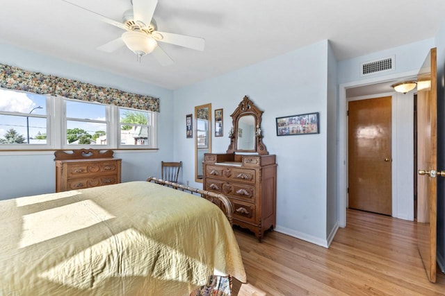 5927 W Addison St Unit 2D, Chicago, IL 60634 - bedroom with light wood-style floors, baseboards, and ceiling fan