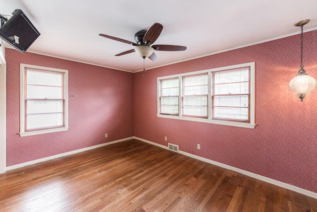609 Moss Pl, Dixon, IL 61021 - spare room with wood-type flooring, ornamental molding, ceiling fan, and baseboards