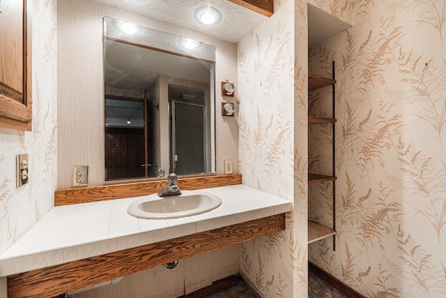 609 Moss Pl, Dixon, IL 61021 - bathroom featuring vanity, wallpapered walls, and a textured ceiling