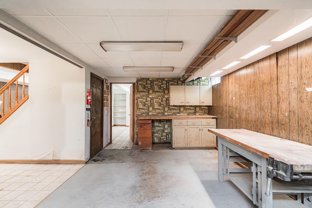 609 Moss Pl, Dixon, IL 61021 - basement with a workshop area, wood walls, and stairs