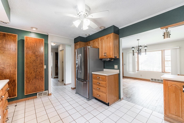 609 Moss Pl, Dixon, IL 61021 - kitchen with stainless steel fridge, a ceiling fan, light countertops, a chandelier, and ornamental molding