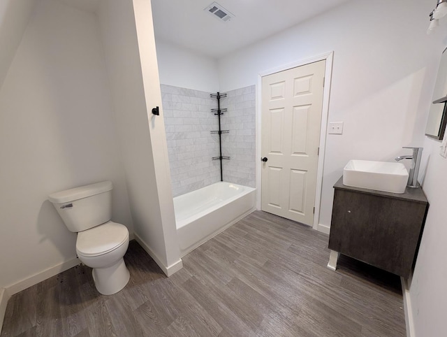 257 Orchard Ave, Kankakee, IL 60901 - full bathroom featuring toilet, wood finished floors, vanity, baseboards, and bathing tub / shower combination