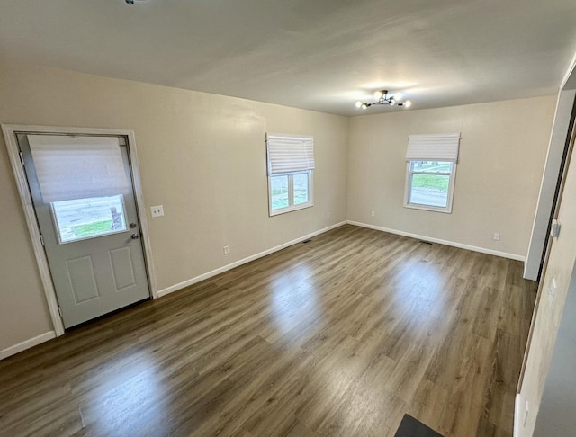 257 Orchard Ave, Kankakee, IL 60901 - unfurnished living room with wood finished floors and baseboards