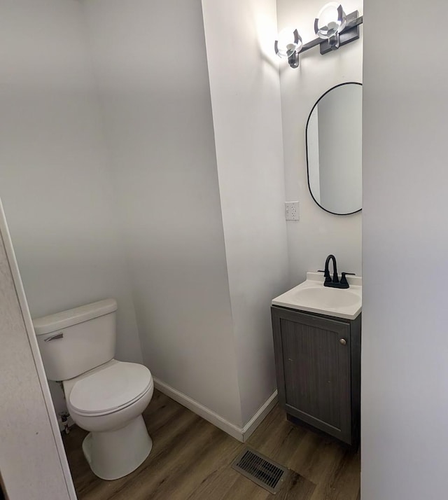 257 Orchard Ave, Kankakee, IL 60901 - bathroom with toilet, wood finished floors, vanity, and baseboards