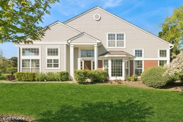 838 Old Checker Rd Unit D-4, Buffalo Grove, IL 60089 - back of house featuring a lawn and brick siding