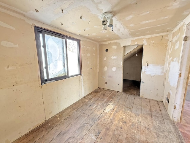 unfurnished room with hardwood / wood-style flooring
