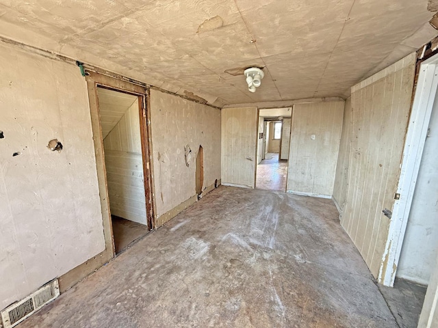 unfurnished room with visible vents and unfinished concrete floors